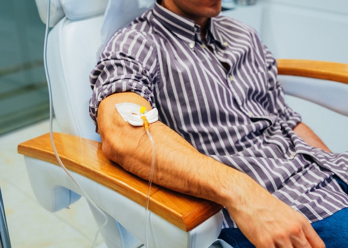 Man receiving intravenous vitamin therapy in beauty clinic IV Therapy College Station TX